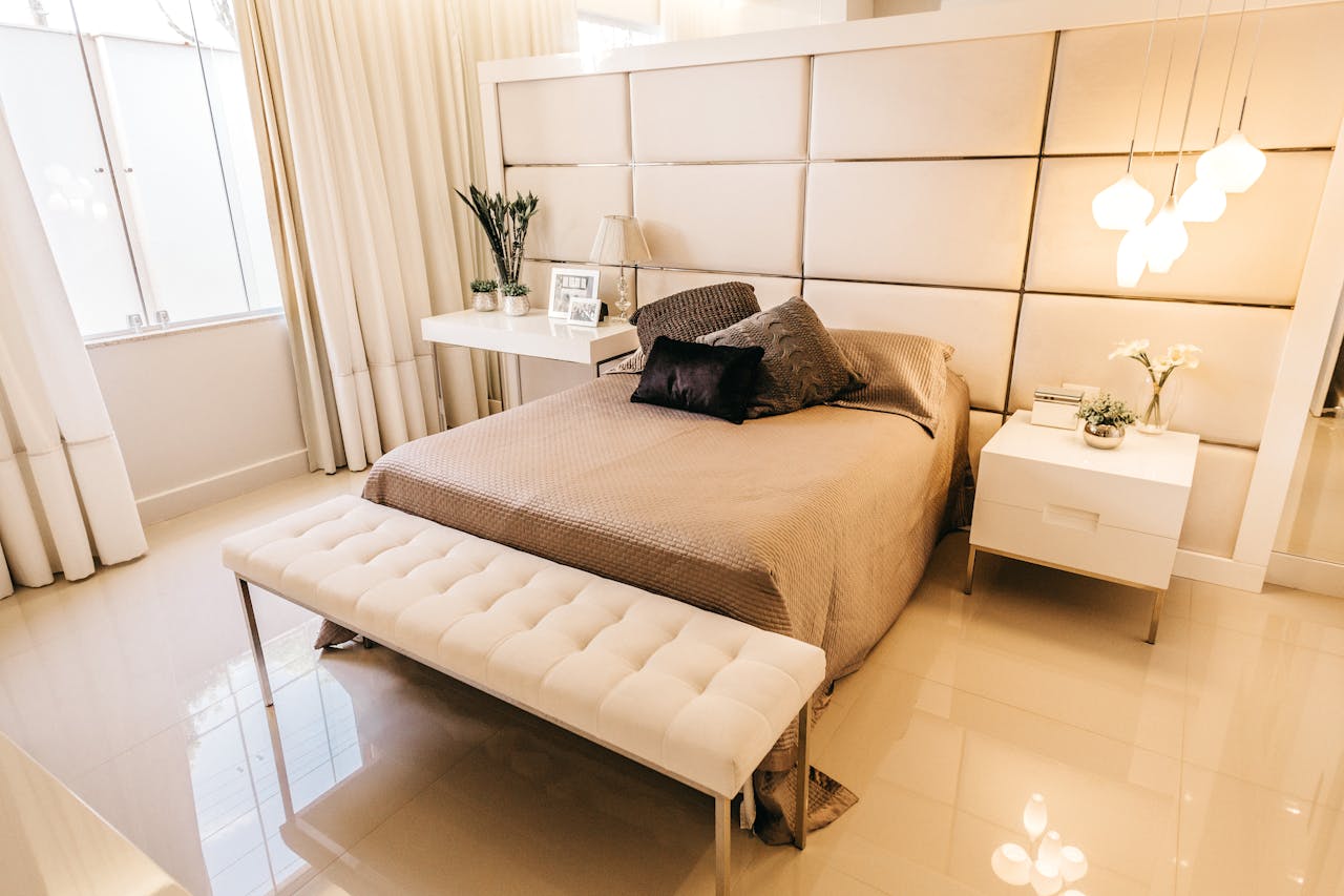 Luxurious modern bedroom featuring elegant design elements, soft lighting, and cozy bedding.